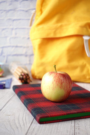 black to school concept with apple on notepad on table.の写真素材