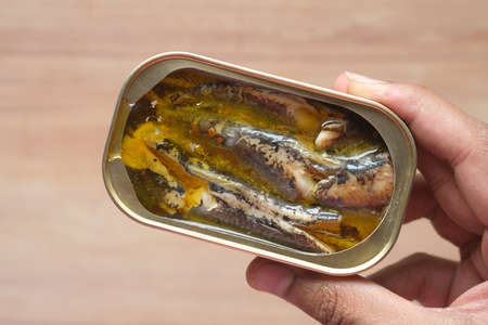 open tin of sardines on white tiles background.の写真素材