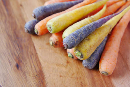 mixed colorful carrot on a chopping boardの写真素材