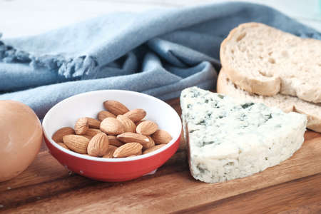 cheese, milk , brown bread and almond nut on table.の写真素材