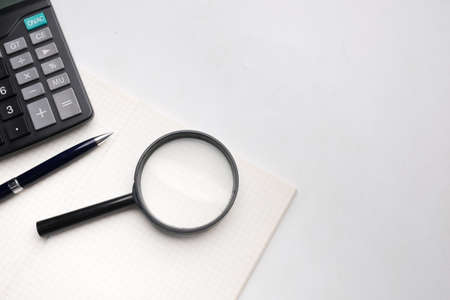 open book and magnifying glass on table.の写真素材
