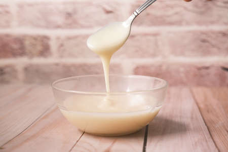 condensed milk in a bowl close up,の写真素材