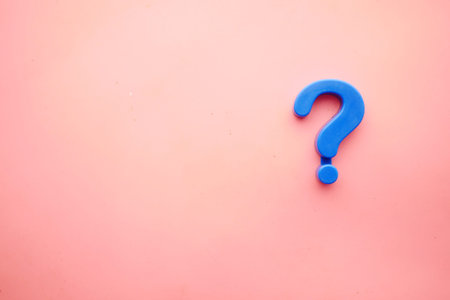 question mark on a pink background with copy spaceの写真素材