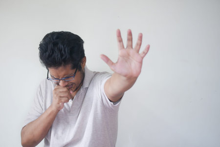 young sick man coughing and sneezes