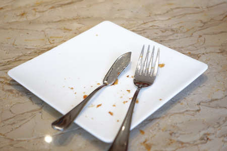 cutlery and empty plate on wooden backgroundの写真素材
