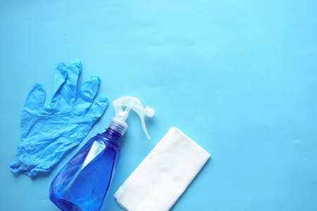 cleaning paper, bottle and hand gloves on blueの写真素材