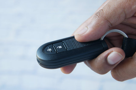 close up of hand hold car key on white background ,