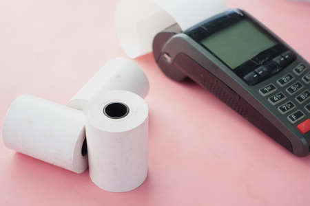 POS machine and long roll paper on blue .の写真素材