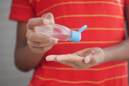 child hand using sanitizer gel for preventing virus with copy space