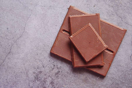 close up of slice of a dark chocolate on black backgroundの写真素材