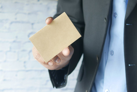 Closeup of blank business note card on mans handの写真素材