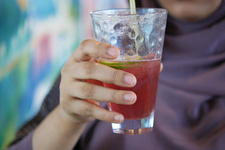 women drinking pomegranate juice close upの写真素材