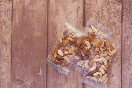 packet of mixed nuts on wooden backgroundの写真素材