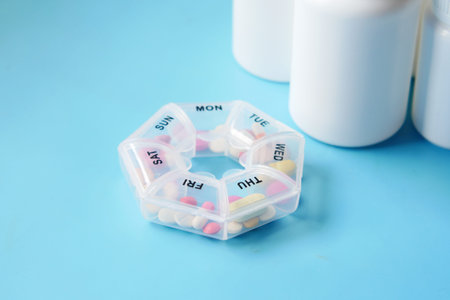 pill box and medical pill container on blueの写真素材