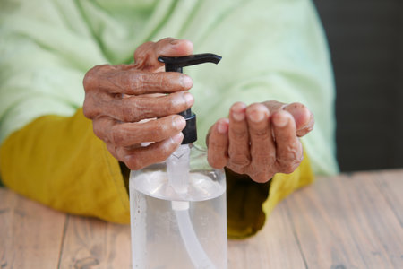 close up of senior women hand using sanitizer gel for preventing virusの写真素材
