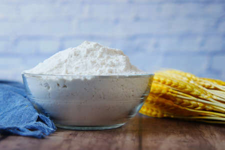 wheat flour in a bowl on tableの写真素材
