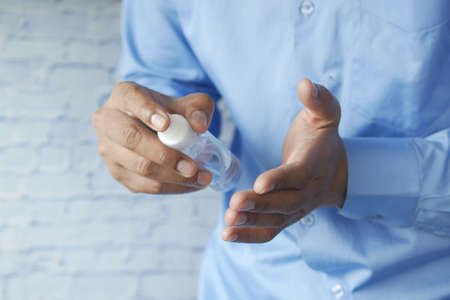 close up of young man hand using hand sanitizer spray.の写真素材