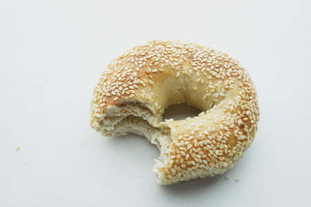 half eaten bagel on white backgroundの写真素材