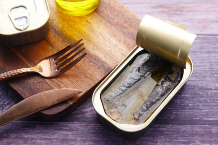open tin of sardines on white tiles background.の写真素材