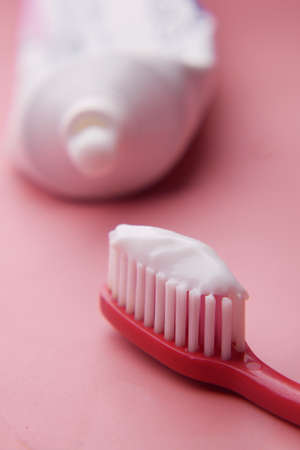 tooth brush and paste on pinkの写真素材