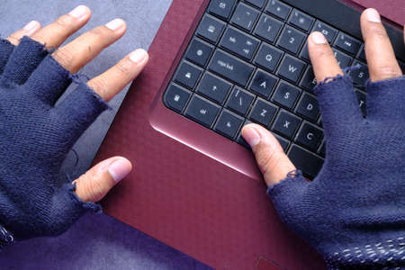 hacker hand stealing data from laptop top downの写真素材