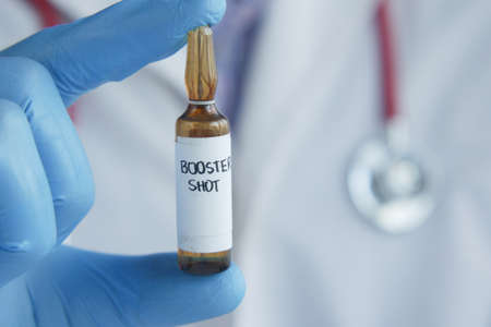 doctor hand hold booster shot dose coronavirus vaccineの写真素材