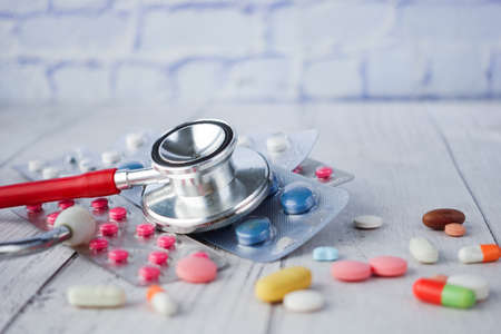 medical pills , blister pack and stethoscope on tableの写真素材