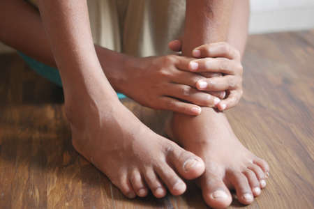 child boy suffering pain on feetの写真素材