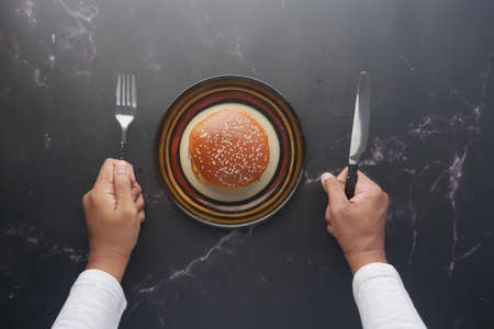 hungry man waiting for eating beef burger on table close upの写真素材