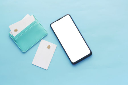 smart phone with empty screen , credit card on blue background