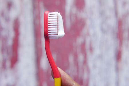 hand holding tooth brush with pasteの写真素材