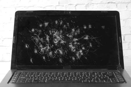 broken laptop screen on table close upの写真素材