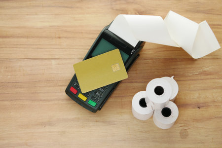 contactless payment concept with credit card and pos machine on table