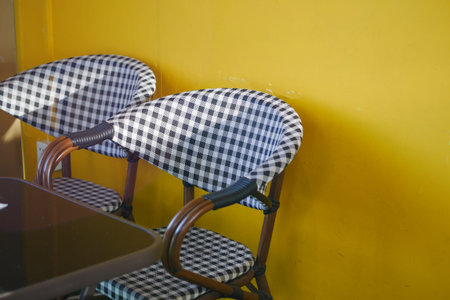 empty chair at cafe against yellow backgroundの写真素材