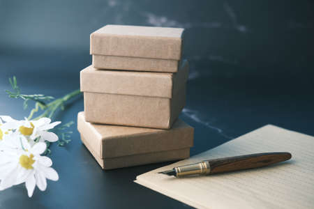 gift box , envelope , empty paper and fountain pen on tableの写真素材
