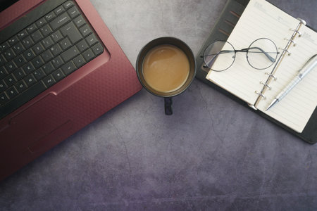 modern office desk with laptop and stationary on tableの写真素材
