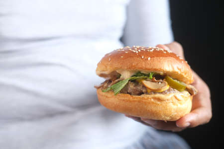 fat man waiting for eating beef burger, selective focusの写真素材