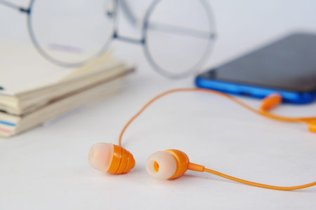 smart phone and headphone on wooden background .