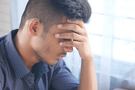 Depressed man feeling sick and worried about financial problem
