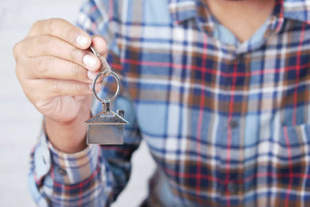 the concept of finance concept , man holding house in handの写真素材