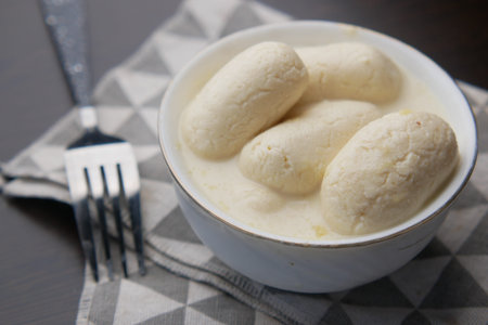 close up of indian sweet in a bowl on table.