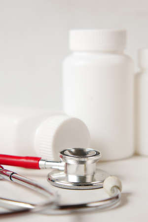 medical pill container and stethoscope on white backgroundの写真素材