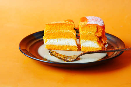 chocolate and cream cake on a plate on tableの写真素材