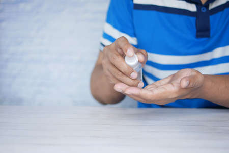 close up of young man hand using hand sanitizer spray.の写真素材