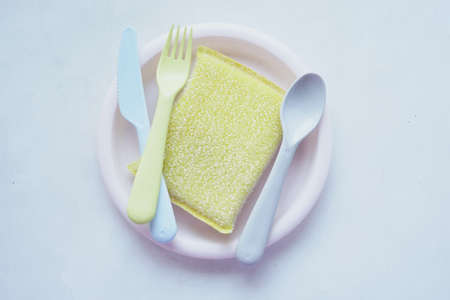 sponge , rubber gloves and colorful plate on whiteの写真素材