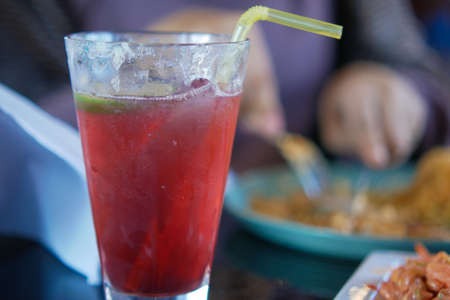 pomegranate juice in a large glass on tableの写真素材