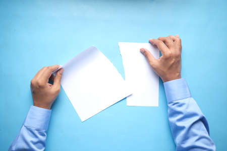 top view of hand on blank paper on tableの写真素材