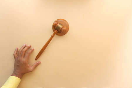 close up of persons hand striking the gavel.の写真素材