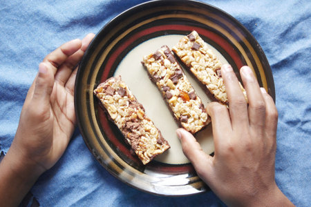 Almond , Raisin and oat protein bars on tableの写真素材