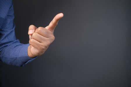 young businessman in suit point finger at cameraの写真素材
